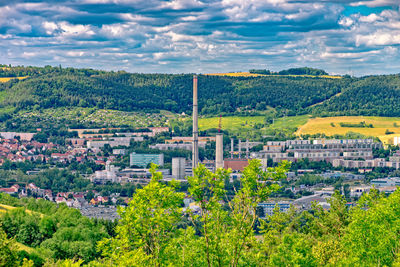 High angle view of trees and buildings in city