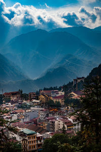 High angle view of townscape and mountains against sky