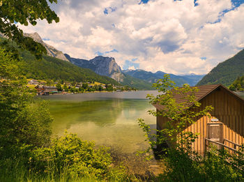 Scenic view of lake by buildings against sky