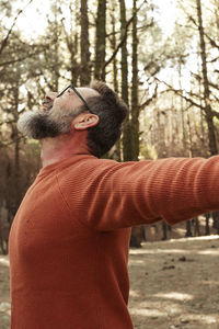 Rear view of man standing in forest