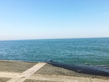 Scenic view of calm sea against clear sky