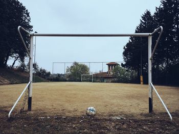 Soccer ball and goal post on playground