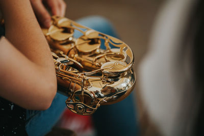 Midsection of man playing saxophone