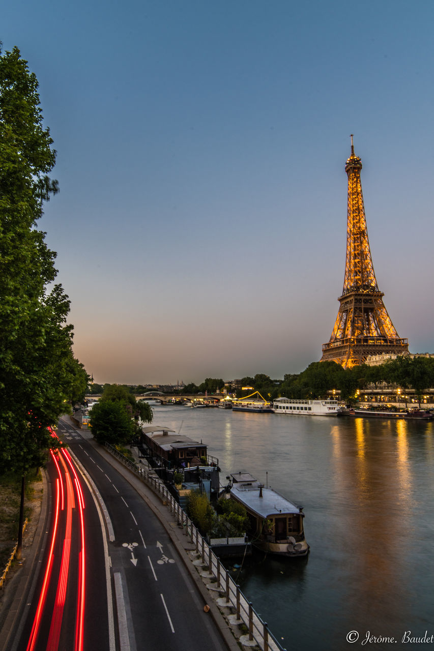 transportation, architecture, built structure, sky, mode of transportation, nature, illuminated, road, city, travel, no people, travel destinations, motion, tower, building exterior, long exposure, water, tree, outdoors