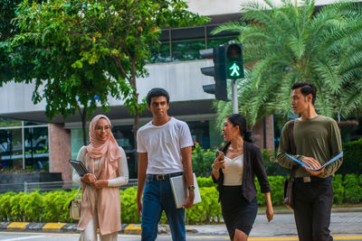 Group of people against plants