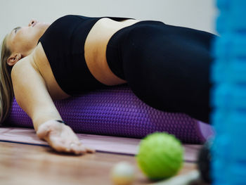 Low section of woman exercising on table