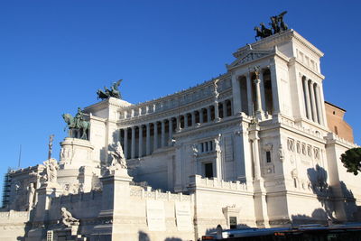 Low angle view of historic building against clear blue sky