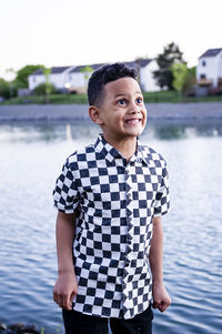 Portrait of smiling boy standing in swimming pool