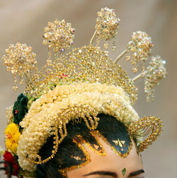 Cropped image of bride wearing headdress during wedding