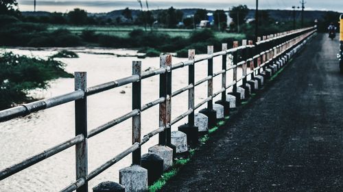 Bridge over river against fence
