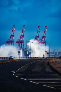 View of industry against blue sky