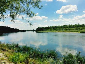 Scenic view of lake against cloudy sky