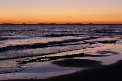 Scenic view of sea against orange sky