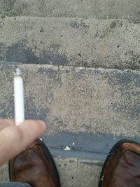 Close-up of hand holding umbrella on street