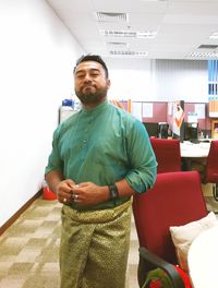 Mid adult man standing indoors