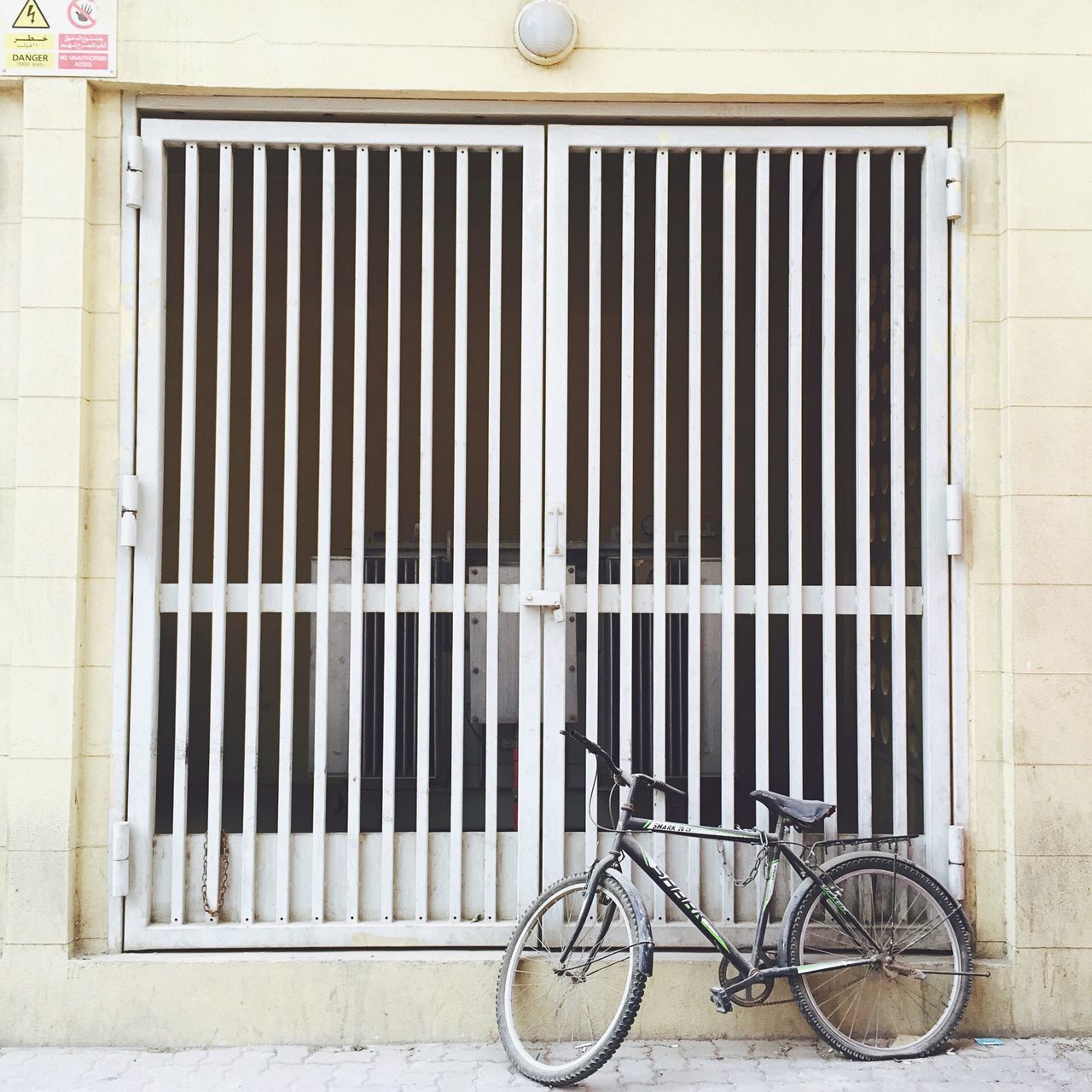 building exterior, architecture, built structure, bicycle, metal, wall - building feature, closed, protection, wall, stationary, safety, pattern, brick wall, day, no people, outdoors, security, window, parked, building