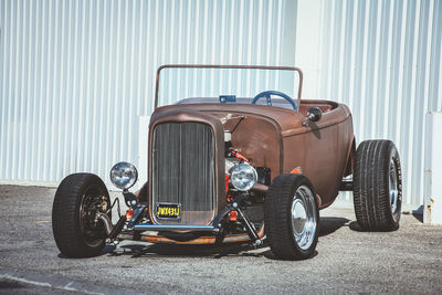 Vintage car parked against wall