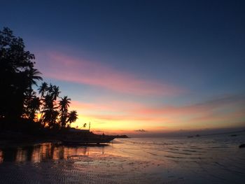 View of calm beach at sunset
