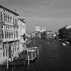 Boats in river with buildings in background