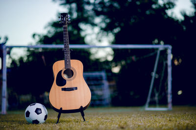 Close-up of guitar on field