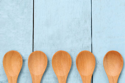Directly above shot of wooden spoons on wooden table