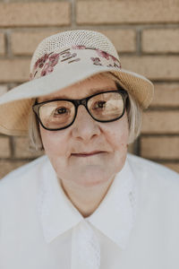 Elderly woman wearing hat and eyeglasses