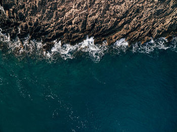 High angle view of rocks in sea