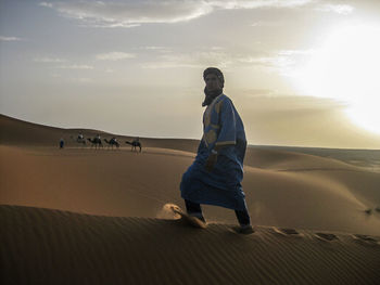 Full length of man walking on sand at beach