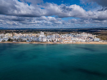 Scenic view of sea and buildings against sky