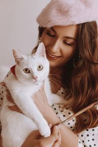 Portrait of young woman with cat