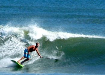 People surfing in sea