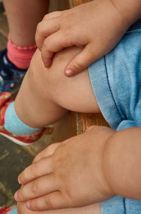 Midsection of baby sitting on bench