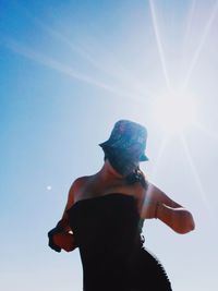 Low angle view of man against sky on sunny day