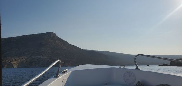Scenic view of sea and mountains against sky