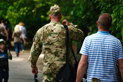 Rear view of people walking outdoors