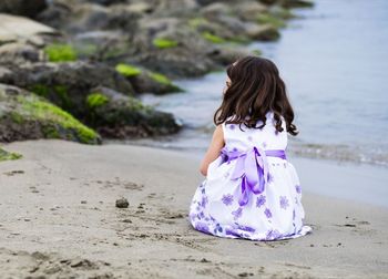 Rear view of girl playing on beach