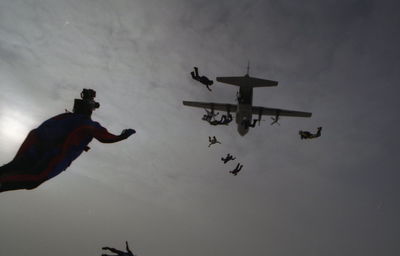 Low angle view of man in airplane against sky