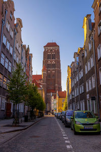 Street amidst buildings against sky in city