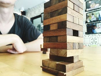 Close-up of man by stack of toy blocks