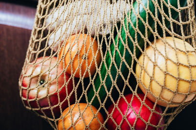 Close-up of vegetables with fruits in mesh bag