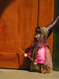 Close-up of man holding umbrella on wood