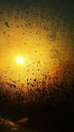 Close-up of water against sky during sunset