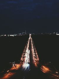 Illuminated city against sky at night