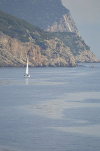 Sailboat sailing on sea against sky