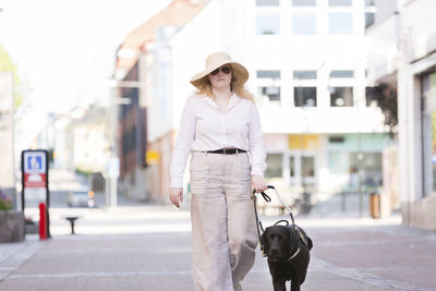 Woman walking with assistance dog