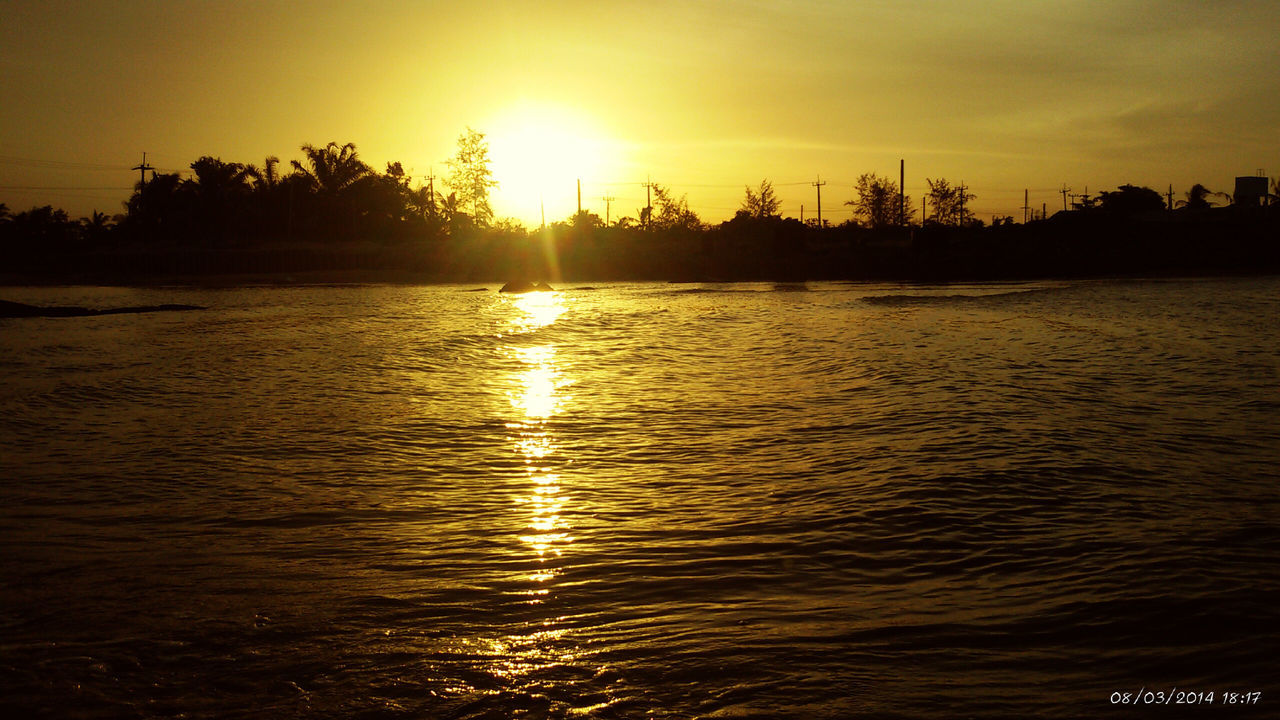 sunset, water, sun, reflection, silhouette, tranquil scene, scenics, tranquility, waterfront, beauty in nature, orange color, sky, rippled, sunlight, idyllic, nature, tree, lake, river, sea