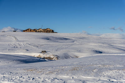 Scenic view of snowcapped mountains against clear blue sky