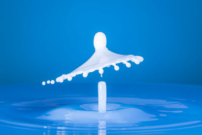 Close-up of water splashing against blue background