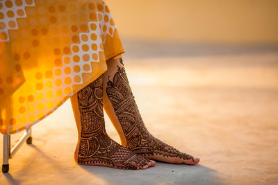 Low section of woman with henna tattoo