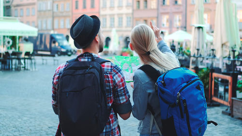 Rear view of people walking on street